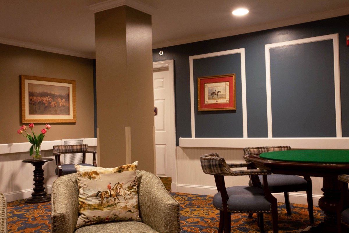 A cozy living room with modern decor, featuring a seating area and a table.