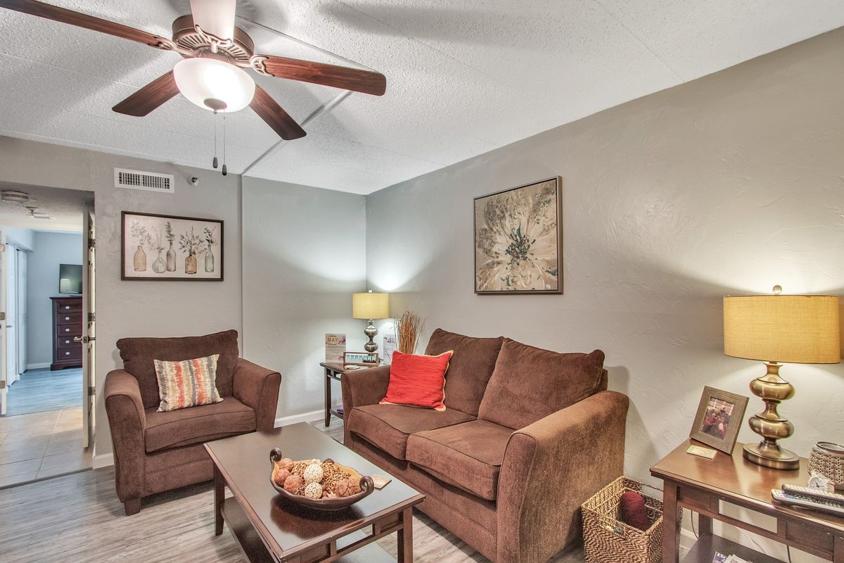Cozy living room with brown sofas and modern decor.