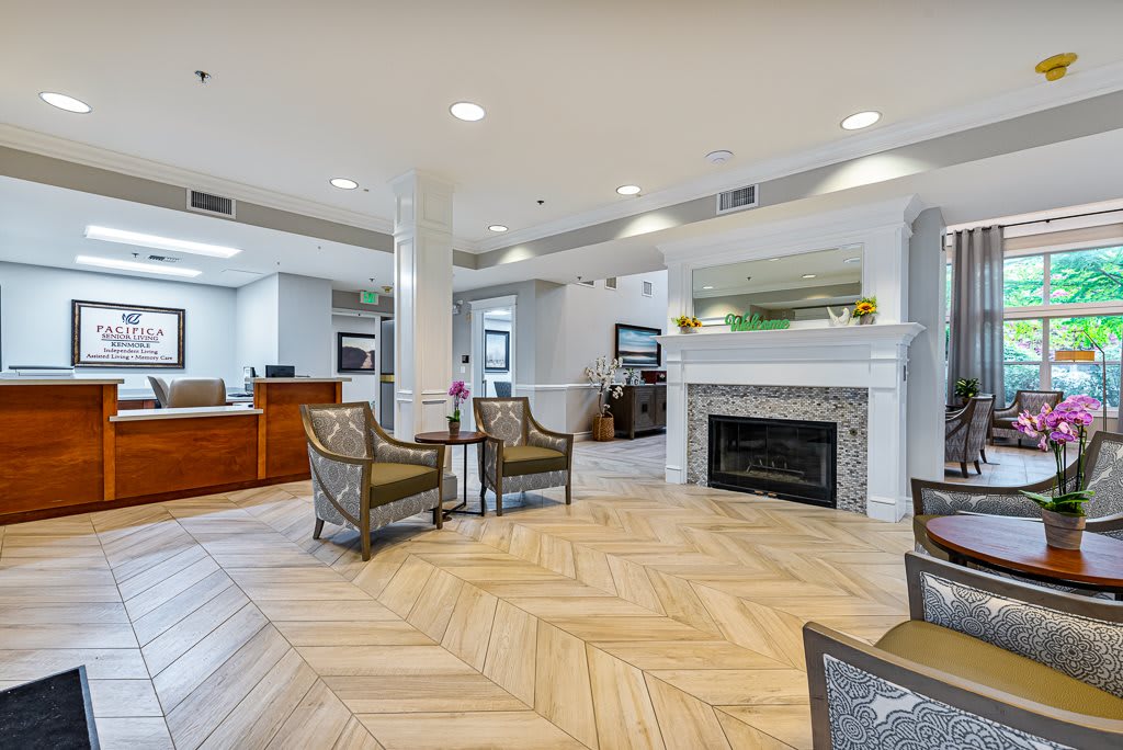 A modern lobby with a fireplace and comfortable seating.