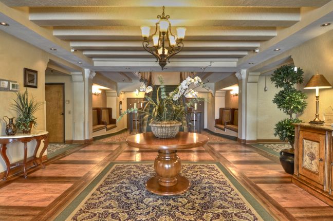 Elegantly decorated lobby with a central plant arrangement and chandelier lighting.