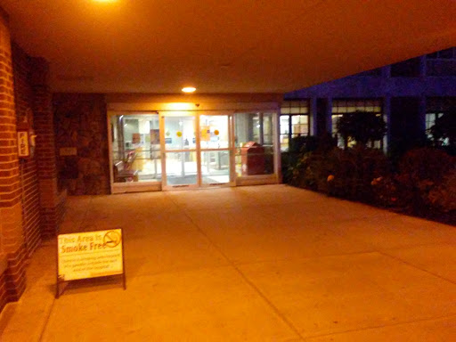 The illuminated entrance to a building at night, showcasing the welcoming atmosphere.
