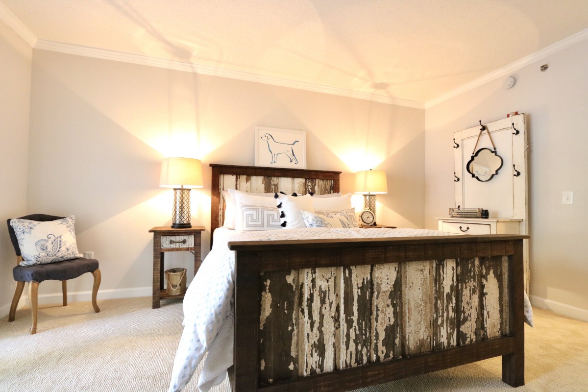 A cozy bedroom with rustic wooden furniture and warm lighting.