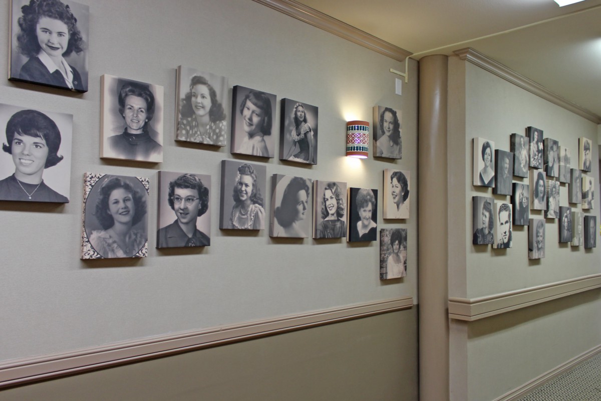 A hallway featuring a gallery wall of black and white portrait photographs.