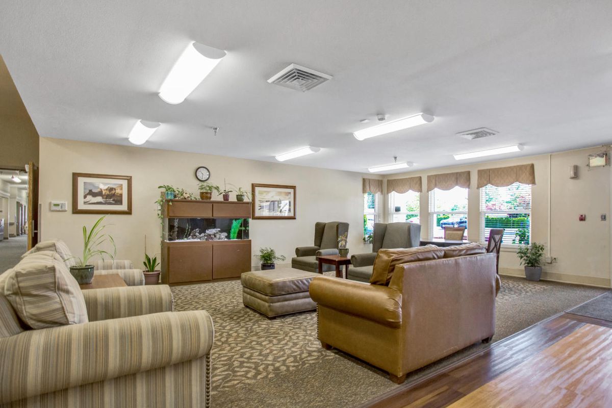 A cozy lounge area with comfortable seating and ample natural light.