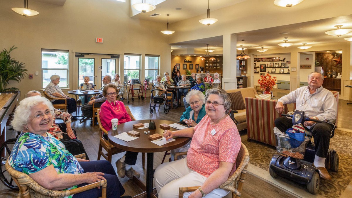 A group of elderly individuals socializing in a senior community center.
