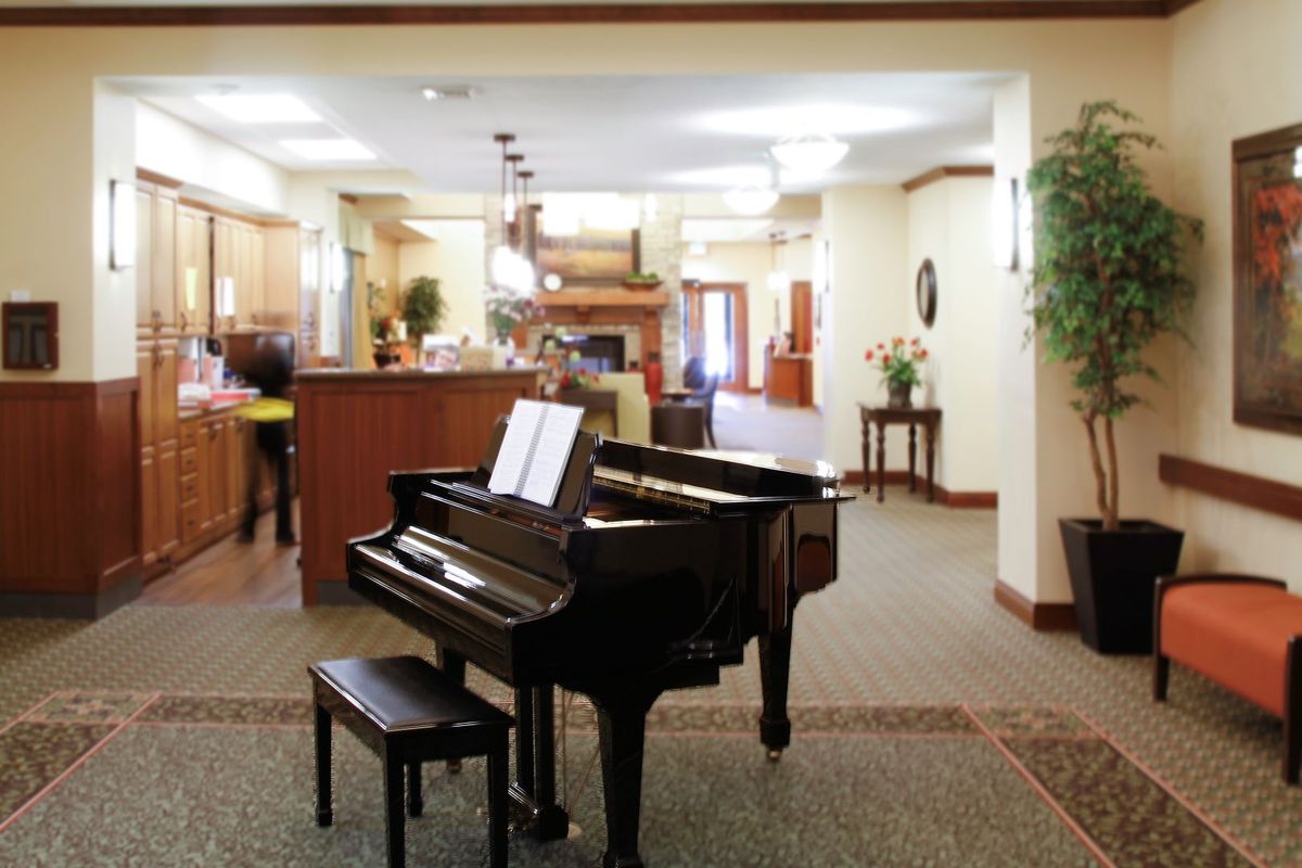 An elegant lobby featuring a grand piano and comfortable seating.