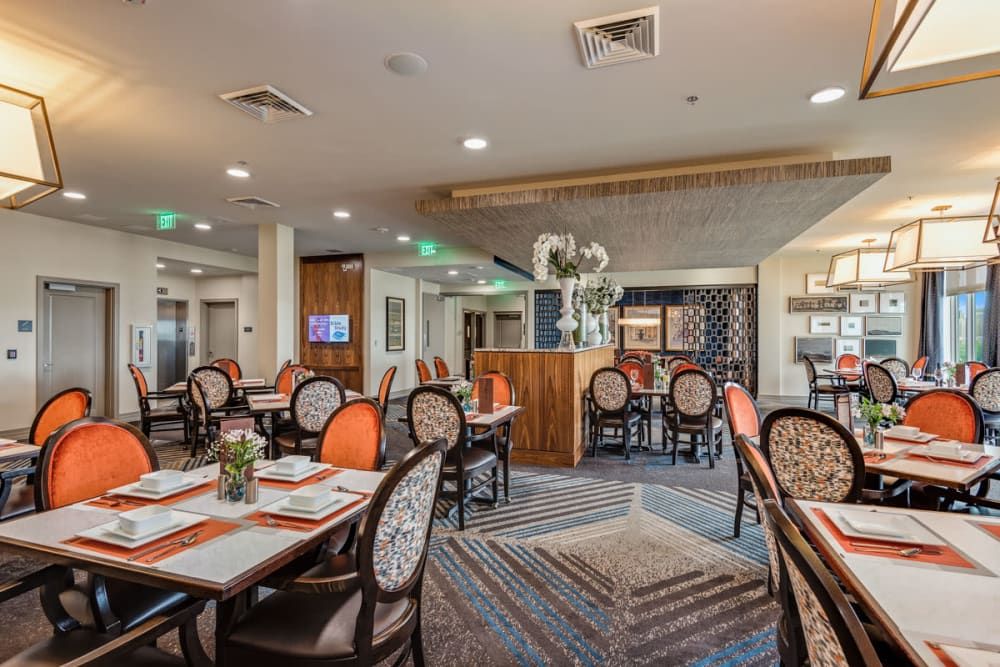 A well-decorated restaurant dining area with neatly arranged tables and chairs.