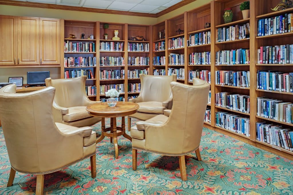 Cozy library nook with bookshelves and a seating area.