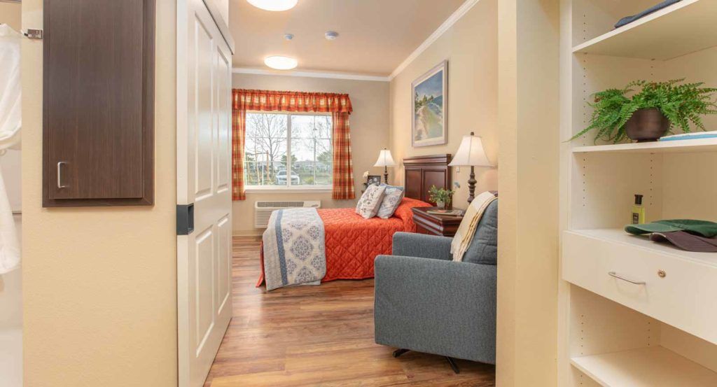 A cozy bedroom with a neatly made bed, stylish decor, and warm lighting.