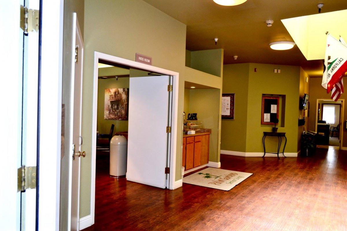 A welcoming lobby area with green walls and wooden flooring.