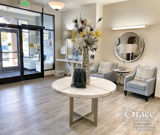 A stylish and inviting lobby featuring modern furniture and a decorative floral centerpiece.