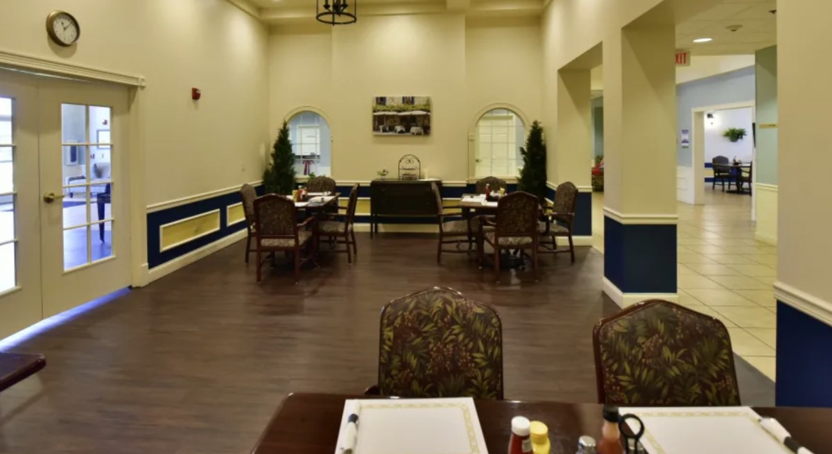 An indoor dining area with neatly arranged tables and chairs, featuring elegant decor.