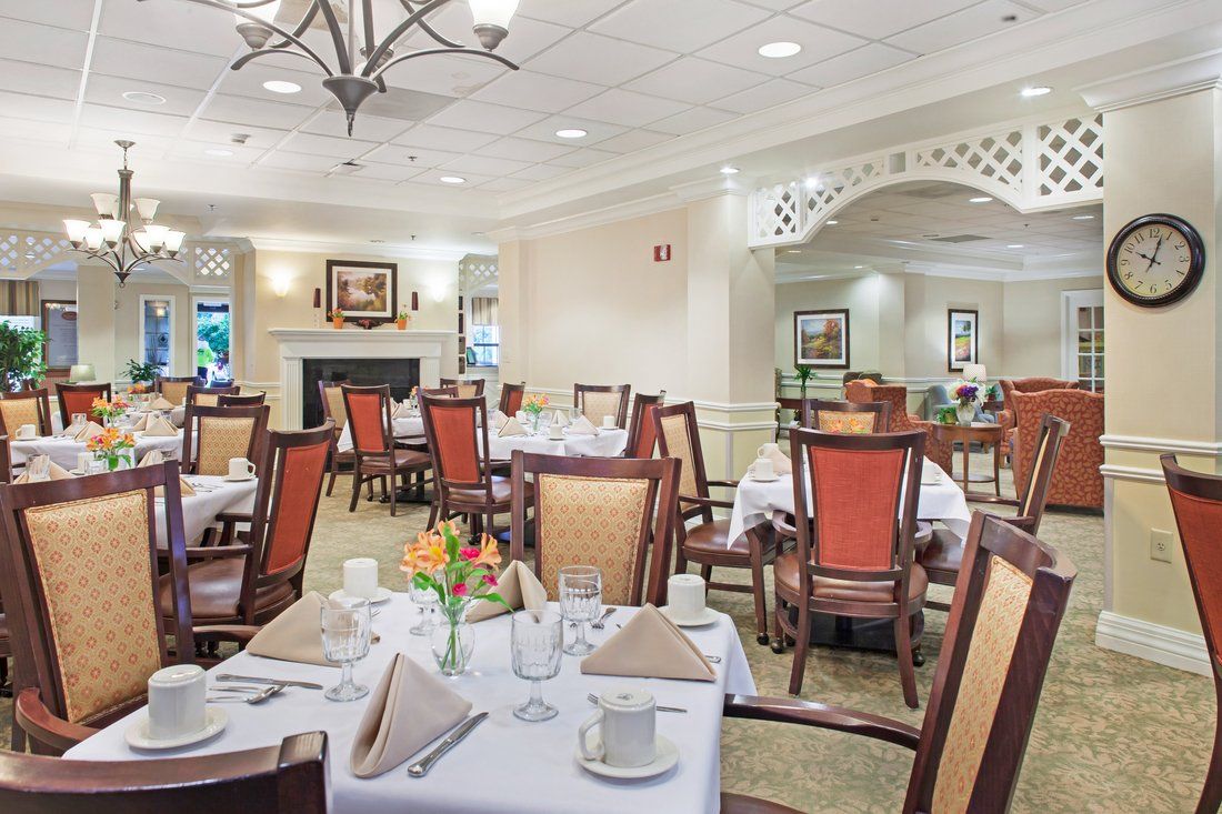 An elegant dining room with neatly arranged tables and chairs.