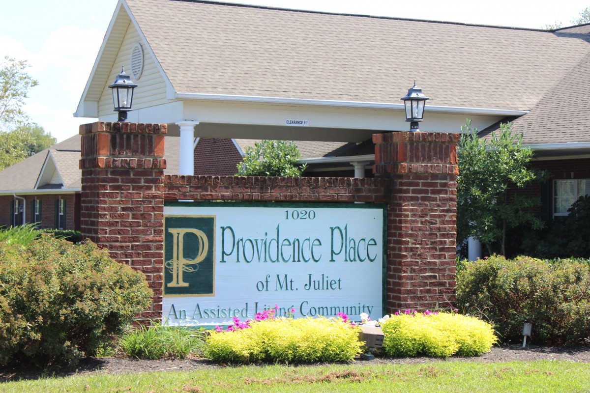 Entrance sign for Providence Place of Mt. Juliet, surrounded by greenery.