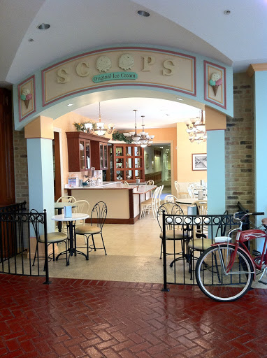 A charming cafe featuring inviting seating arrangements and a bicycle parked outside.