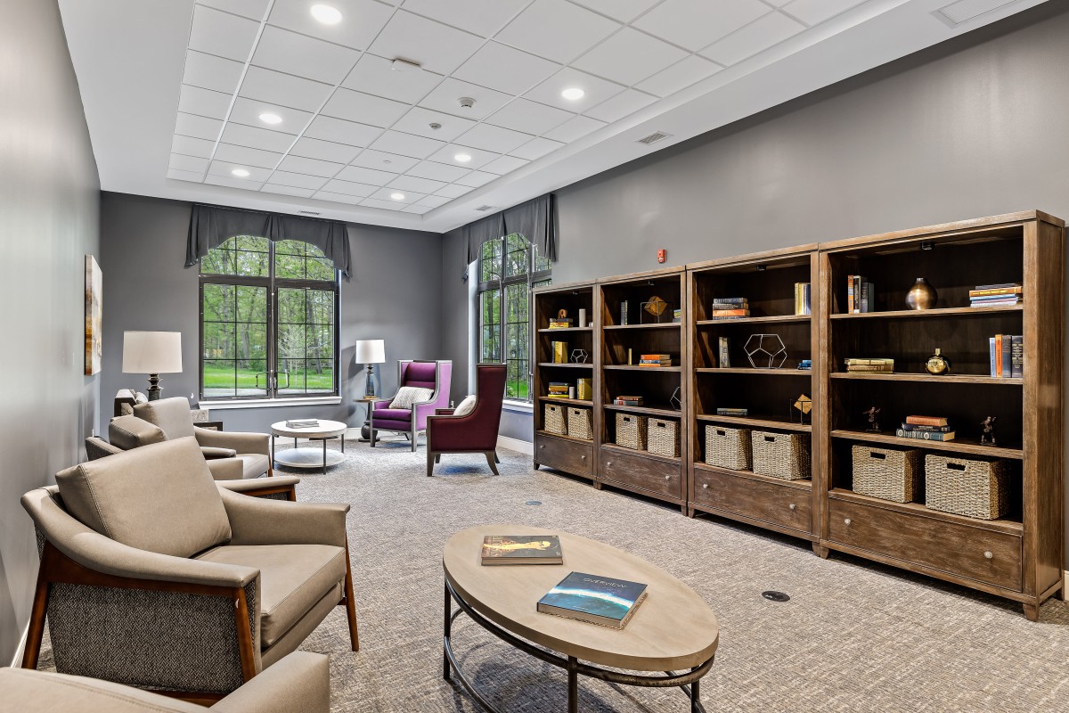 A modern library interior with comfortable seating and large bookshelves.