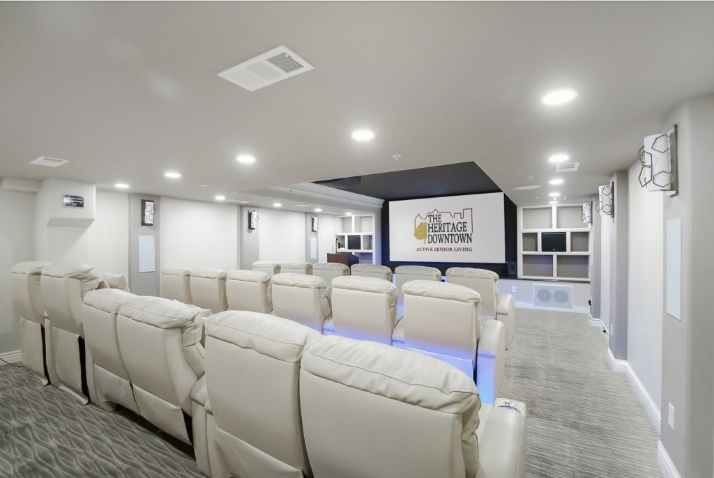 A modern home theater with luxurious seating and a large screen, designed for an immersive entertainment experience.
