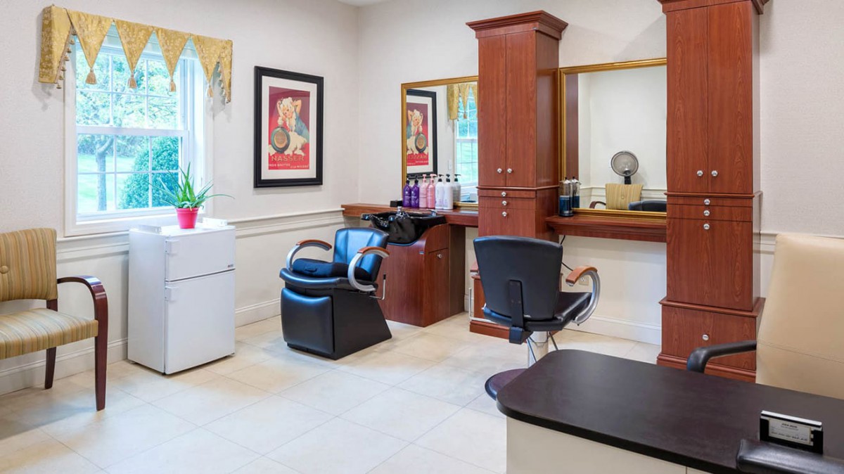 A well-equipped hair salon with seating and mirrors, designed for a comfortable beauty experience.