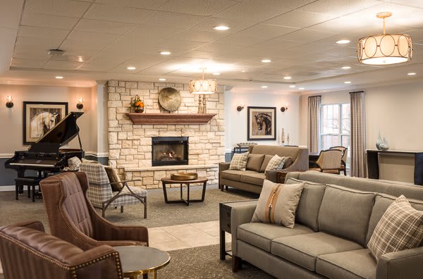 A cozy living room with a stone fireplace and comfortable seating.