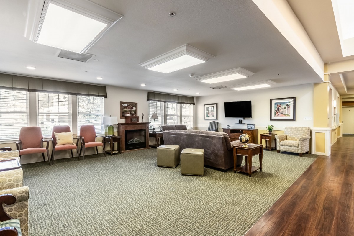 A spacious and well-lit living room with comfortable seating and modern decor.