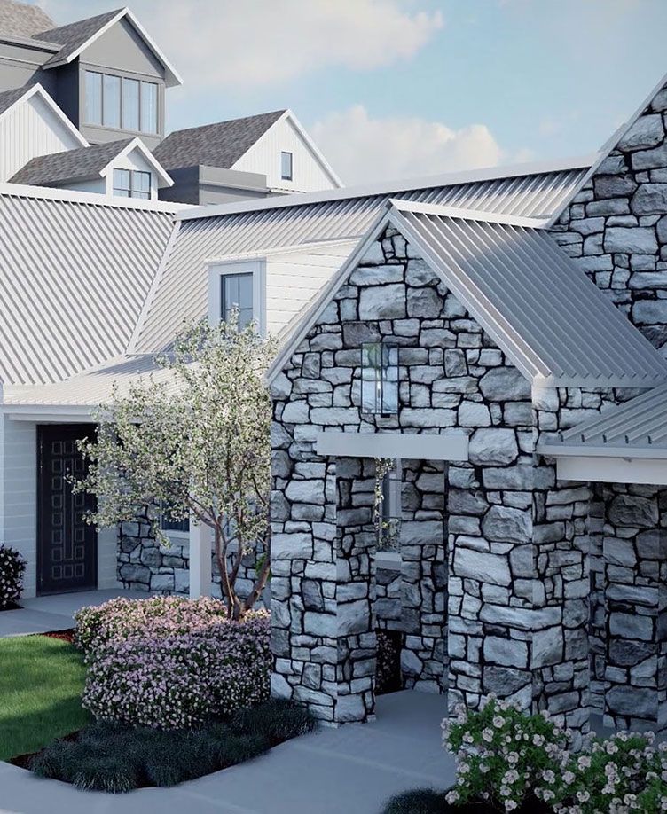 A beautiful stone exterior house with a landscaped front yard.