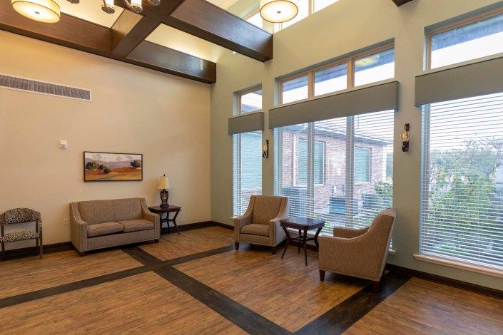 A modern lobby interior with comfortable seating and large windows.