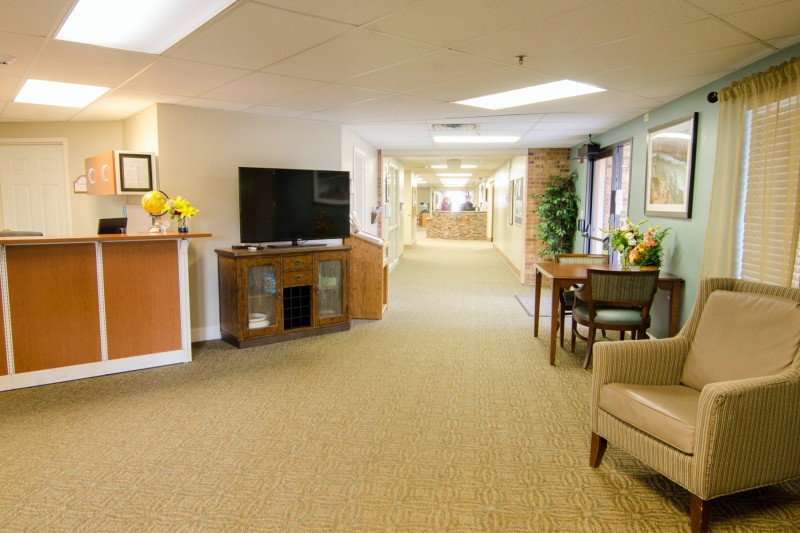 A cozy hallway with a TV area and comfortable seating.