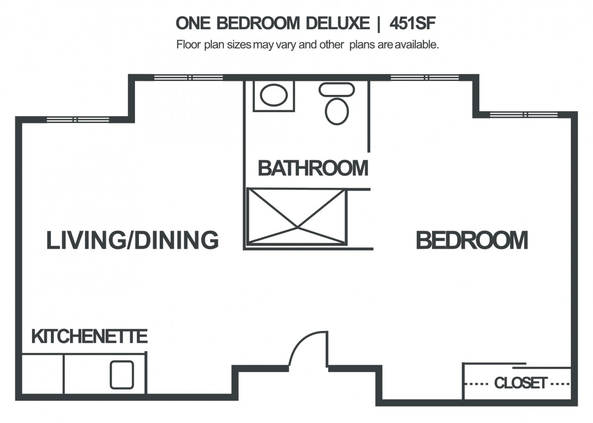 One Bedroom Deluxe Apartment Layout with Bathroom, Kitchenette, and Living/Dining Area.