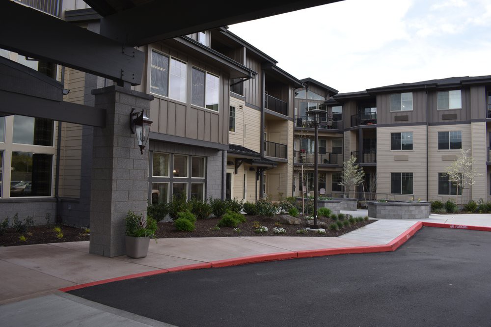 A modern apartment complex with landscaped surroundings.