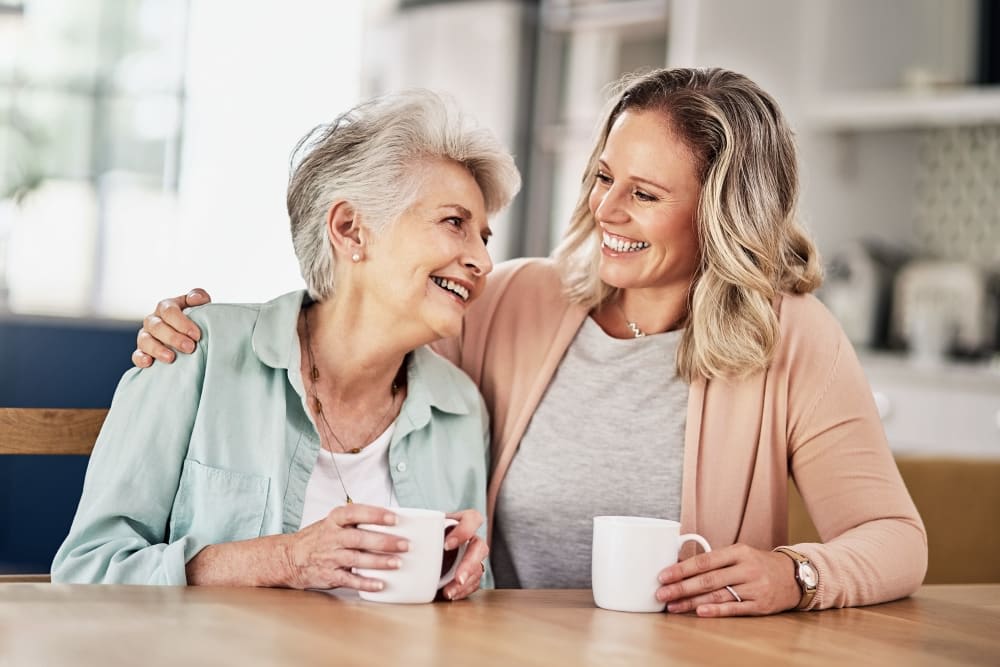 A mother and daughter enjoying a moment together with coffee at home.