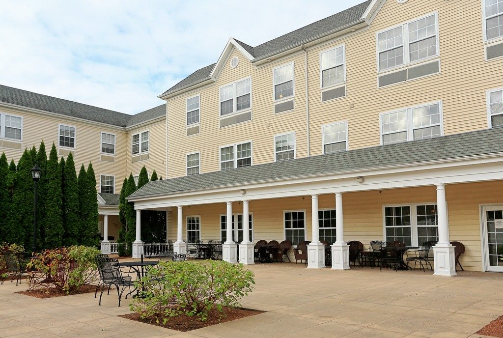 A residential building with a spacious patio and porch area.