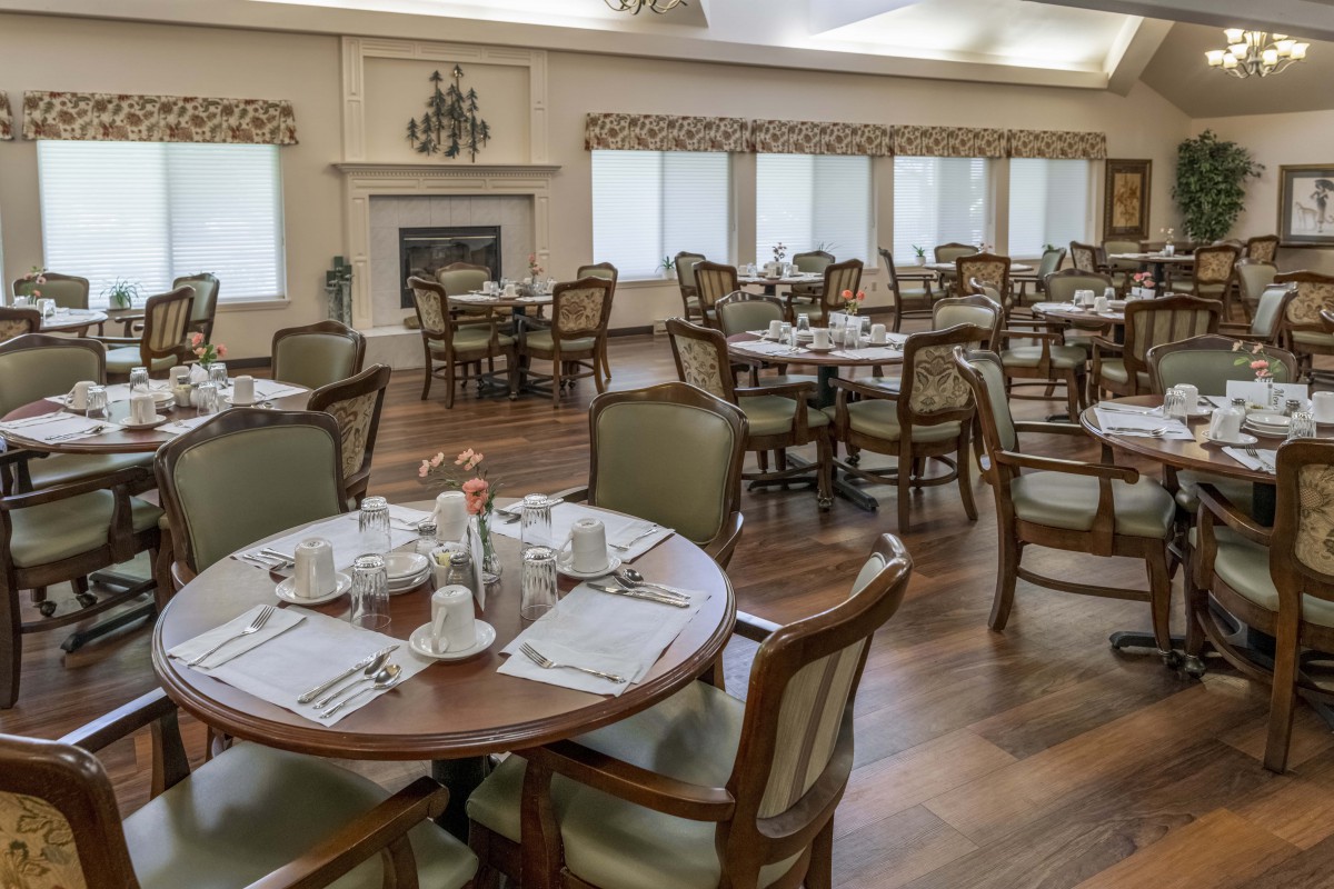 An elegant dining room with neatly arranged tables and chairs, ready for guests.