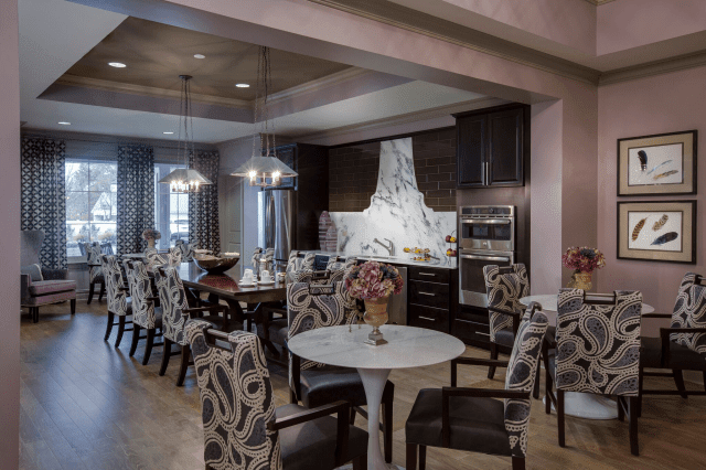 A stylish kitchen and dining area featuring modern decor with elegant furniture and ambient lighting.