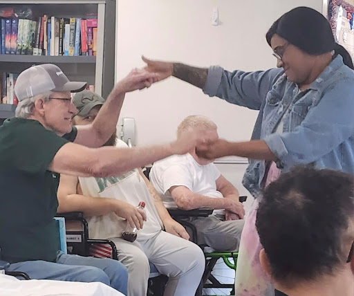 A lively dance interaction between two participants, bringing joy and connection in a community setting.