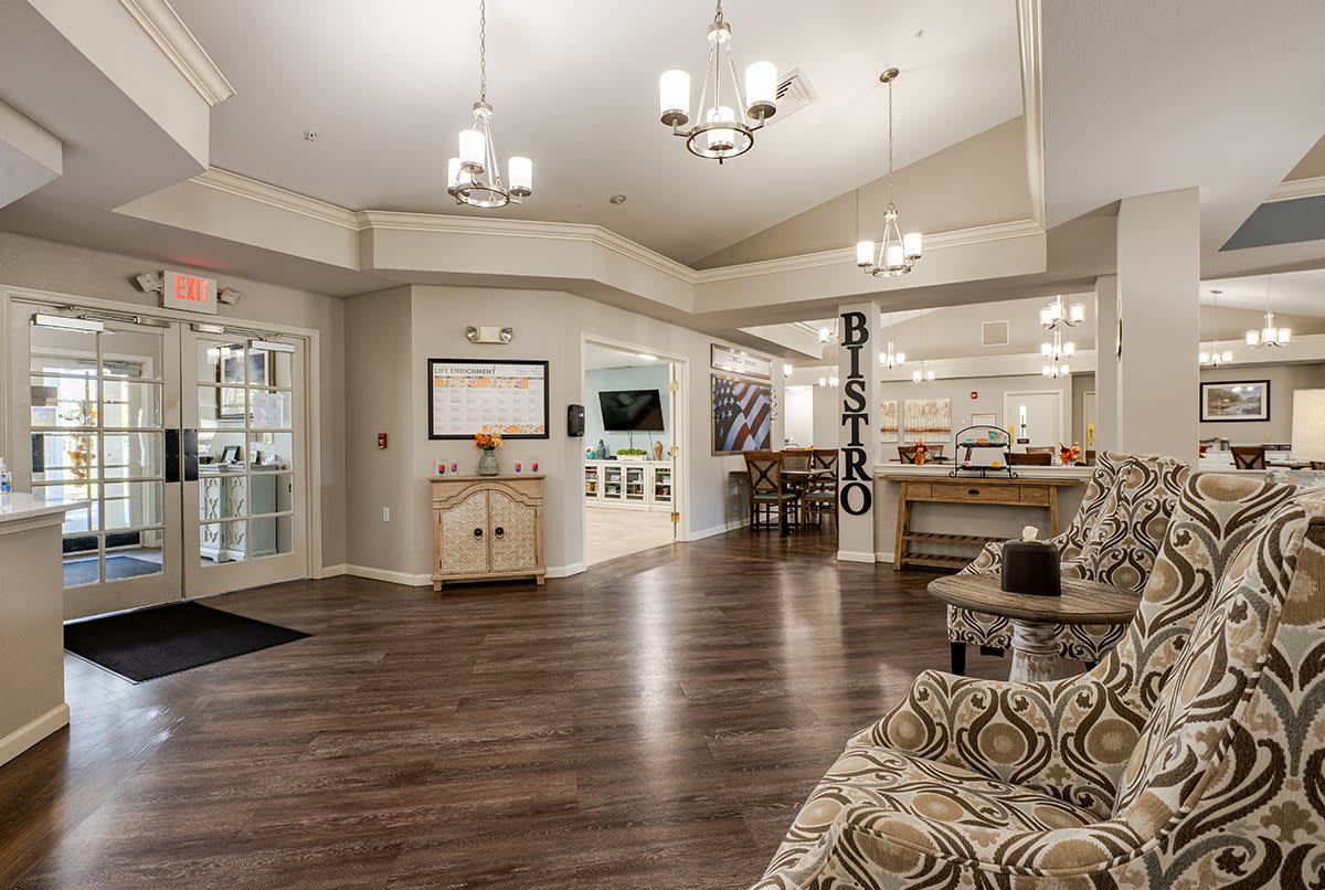 A cozy and welcoming lobby with elegant chandeliers and comfortable seating.