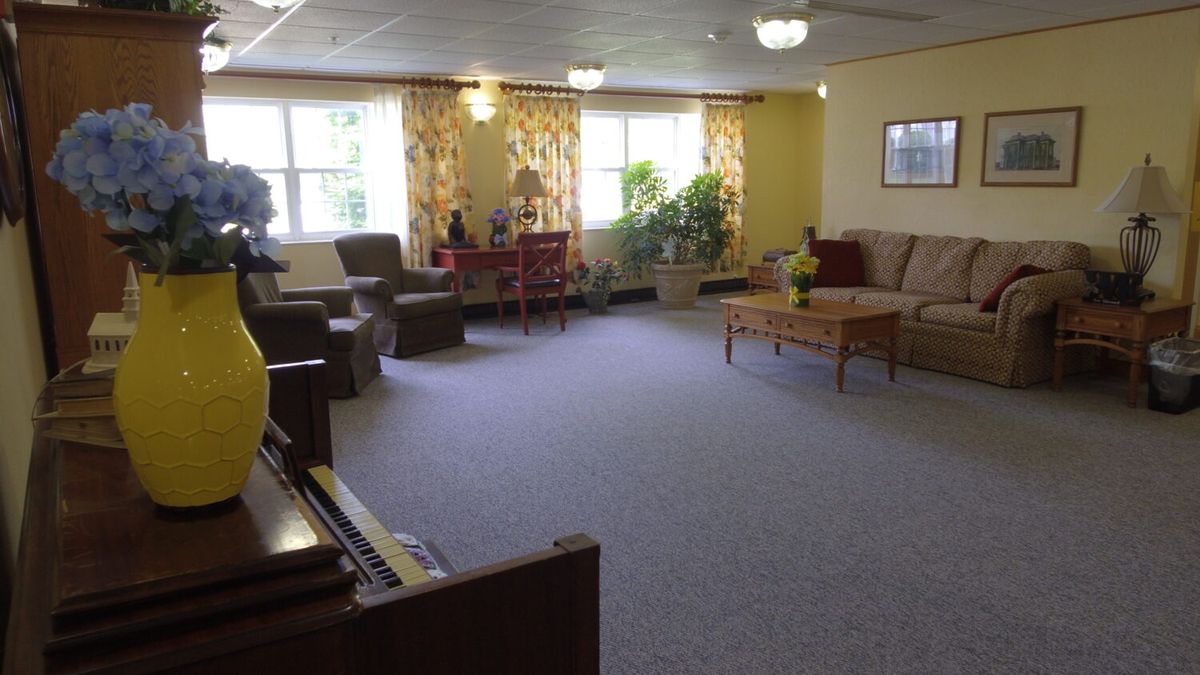 A spacious living room with comfortable furniture and natural light.