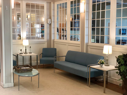 A cozy and modern living space featuring a blue sofa and stylish furniture.