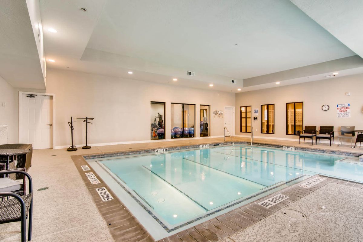 A luxurious indoor swimming pool with elegant lighting and design.