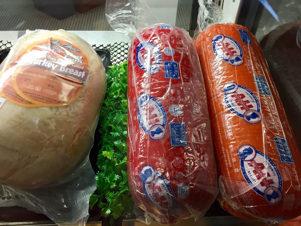 Packaged meats displayed in a deli section.