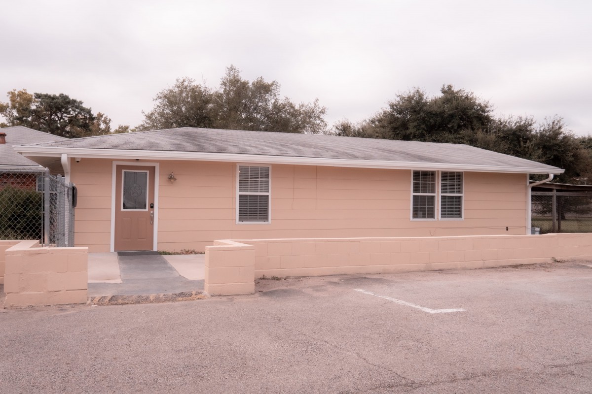 A single-story house with a simple exterior design and a driveway.