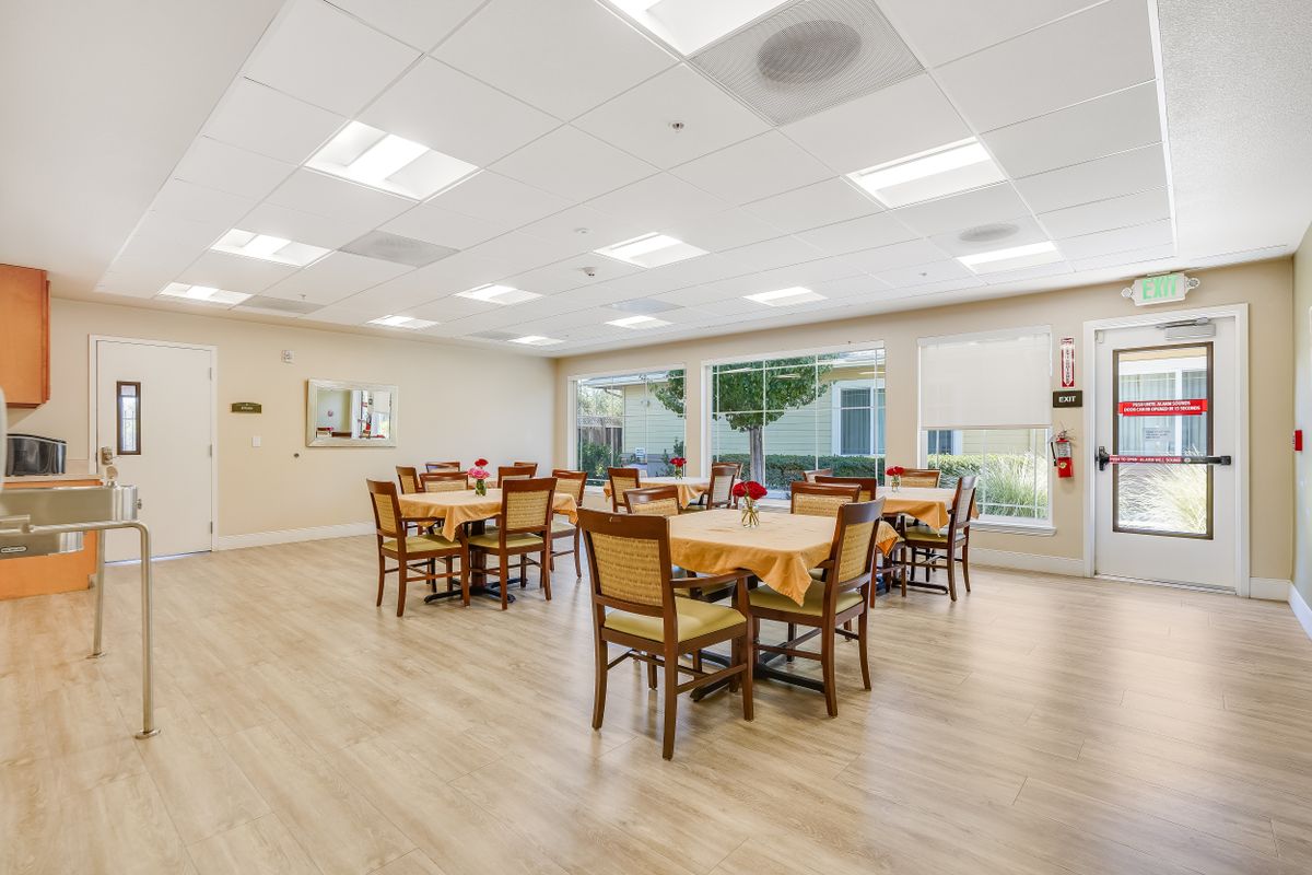 A bright and spacious dining area with tables set up for meals.