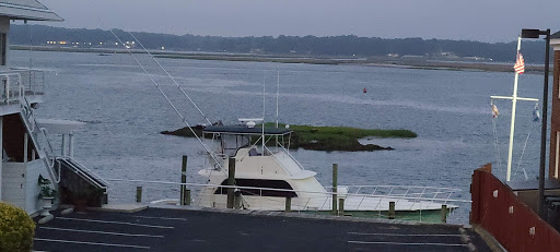 A boat docked near a small island in a calm body of water.
