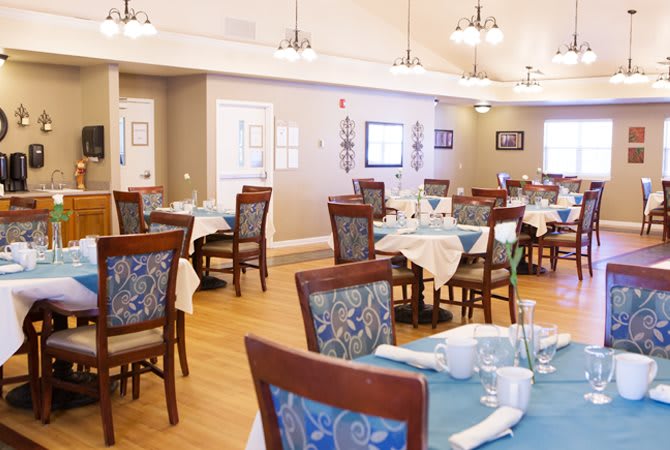 An elegant dining area with neatly arranged tables and chairs, featuring tasteful decor and ambient lighting.