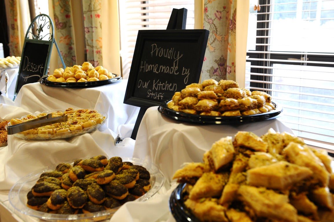 A display of various pastries and baked goods on a buffet table.