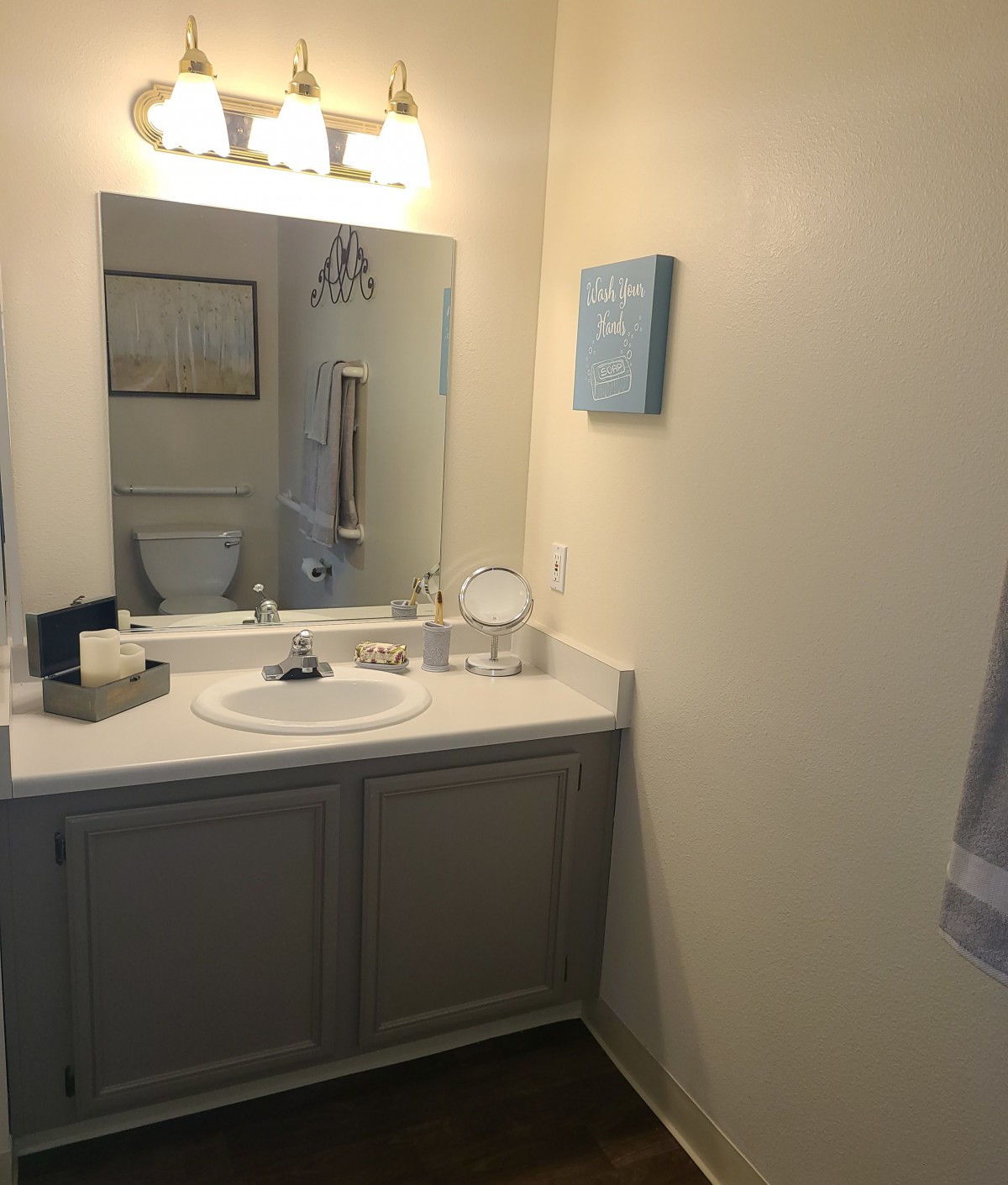 A clean and simple bathroom with a mirror above the sink.