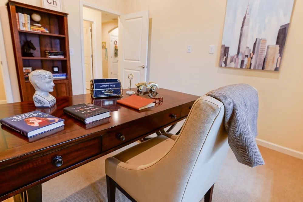 A well-organized home office with a wooden desk and comfortable chair.