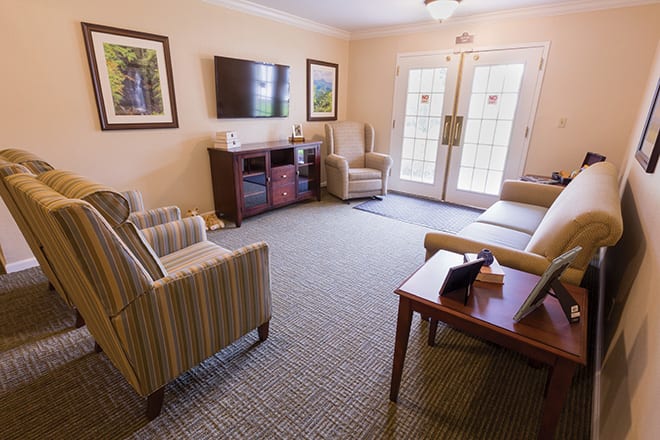 A cozy living room with comfortable seating and a television.