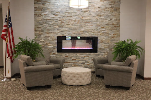 A cozy seating area featuring a modern fireplace and stylish decor.