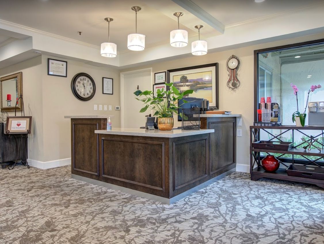 A welcoming reception area with a wooden desk, decorative elements, and soft lighting.