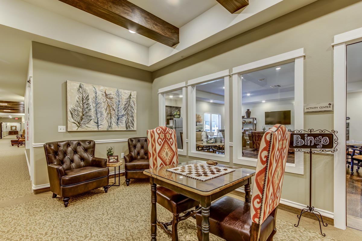 A cozy living area featuring a table with patterned chairs and stylish artwork on the wall.